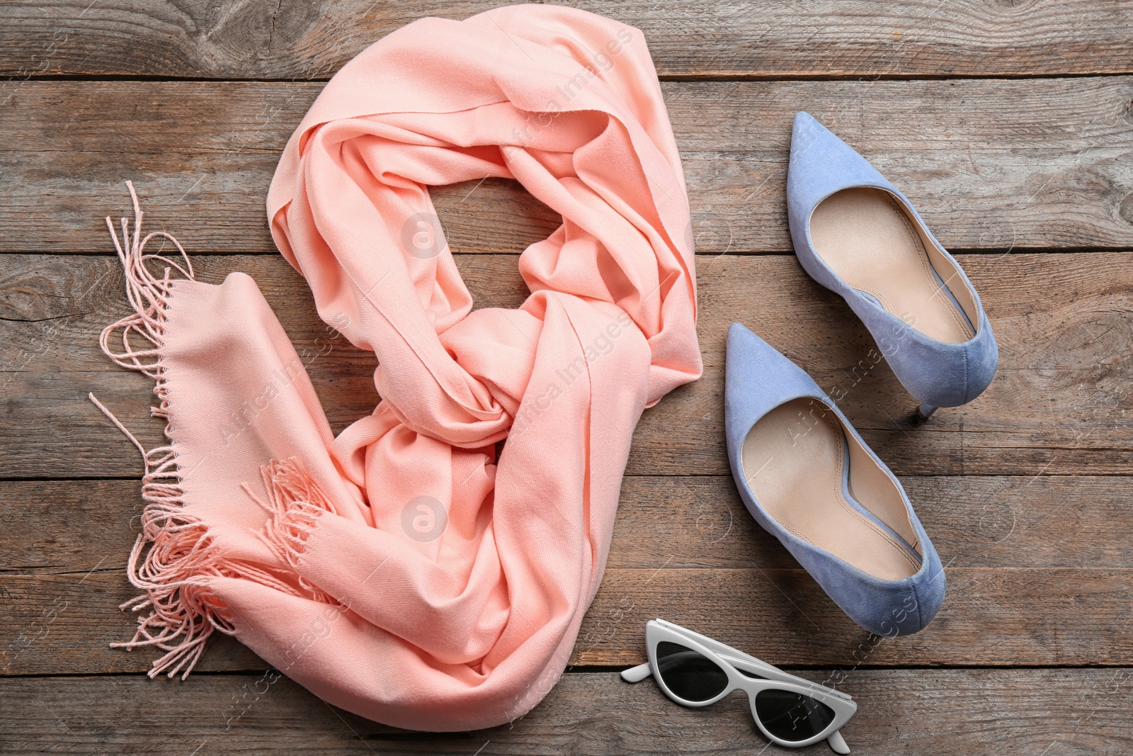 Photo of Flat lay composition with clothes on wooden background