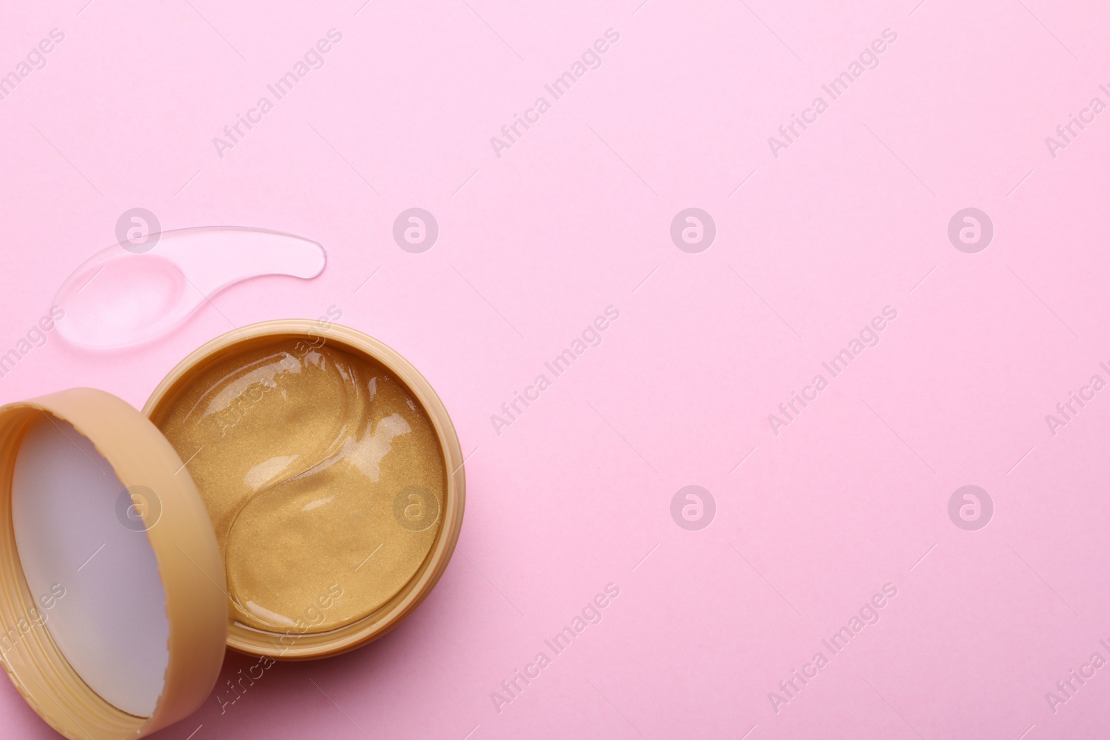 Photo of Package of under eye patches on pink background, flat lay with space for text. Cosmetic product