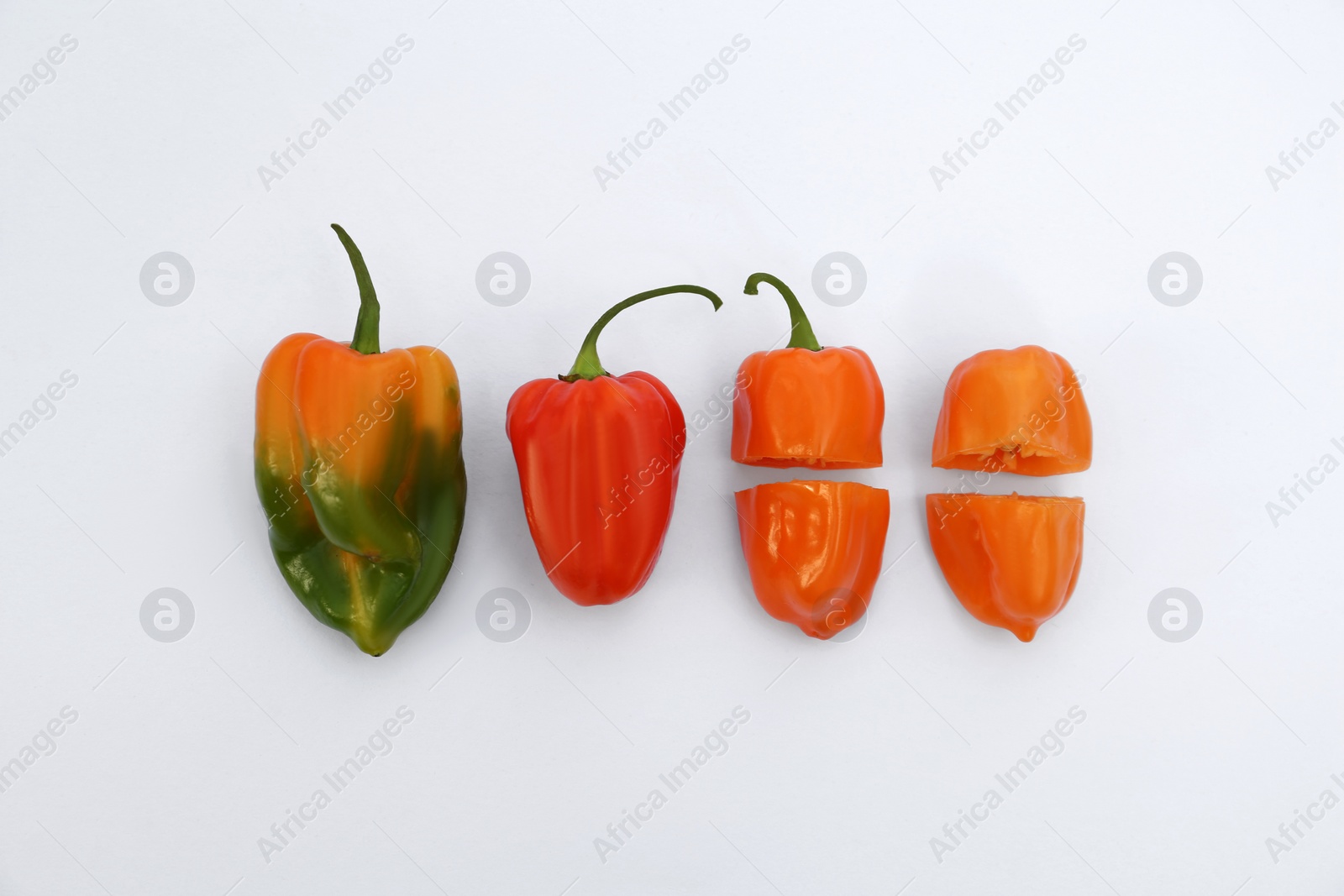 Photo of Different hot chili peppers on white background, flat lay