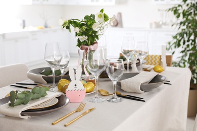 Photo of Beautiful Easter table setting with festive decor indoors