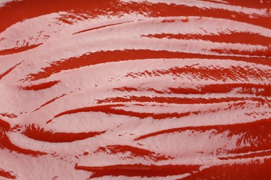 Photo of Tasty ketchup as background, closeup. Tomato sauce