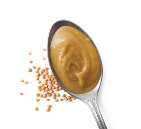 Photo of Fresh tasty mustard sauce in spoon and dry seeds isolated on white, top view
