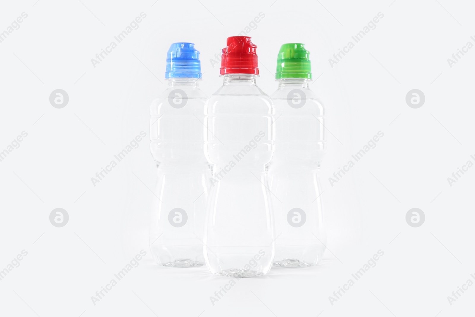 Photo of Plastic bottles with pure water on white background