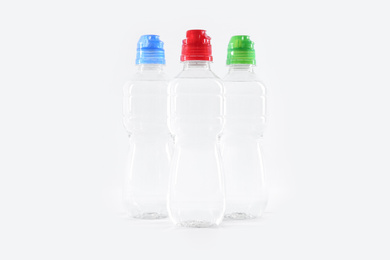 Plastic bottles with pure water on white background