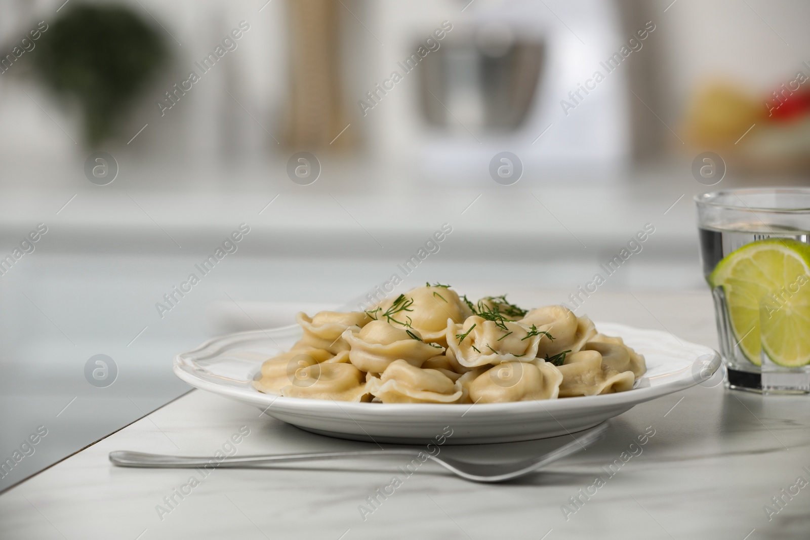 Photo of Delicious dumplings on white table in kitchen