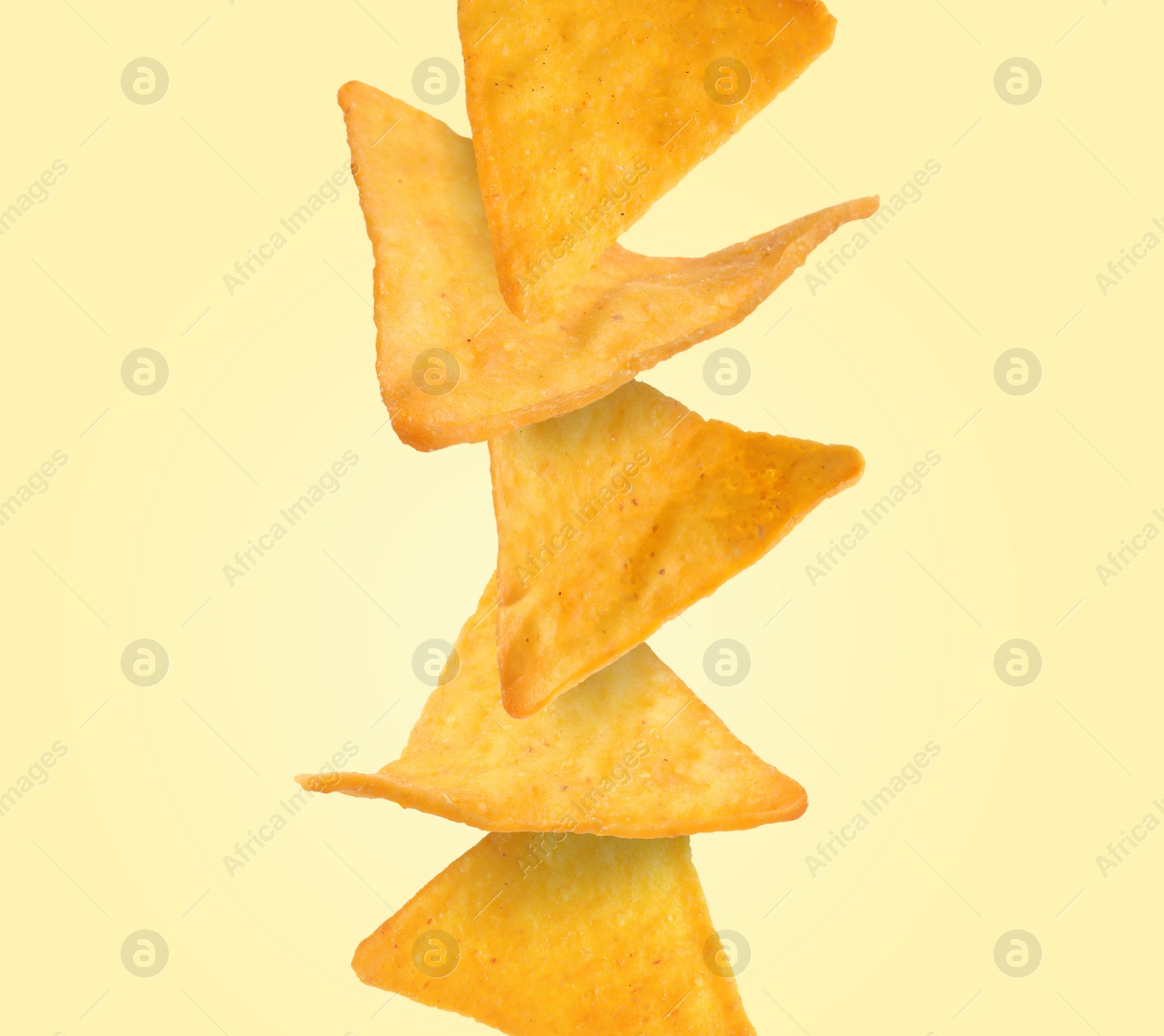 Image of Stack of tasty tortilla chips on beige background