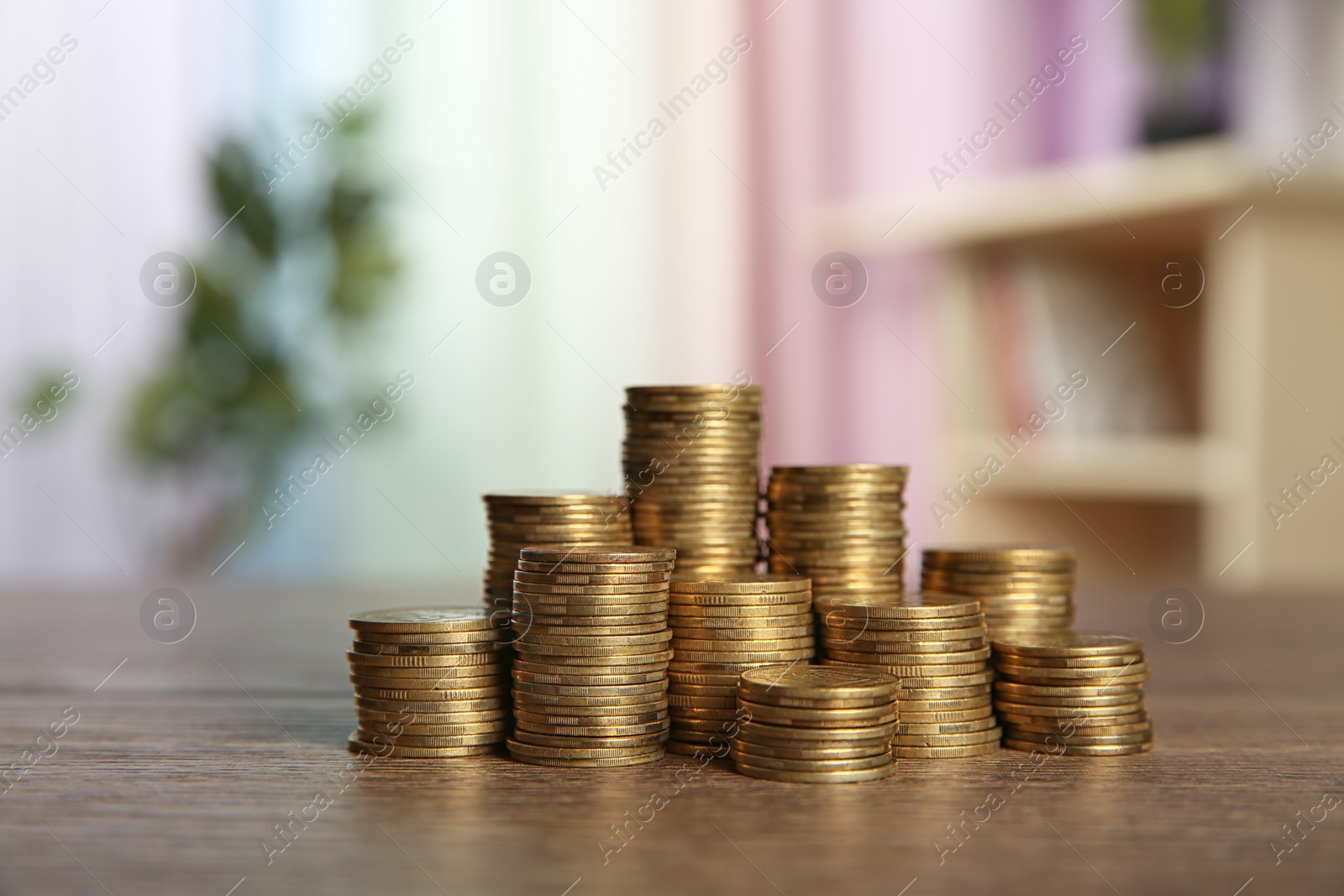 Photo of Many stacks of coins on table in room