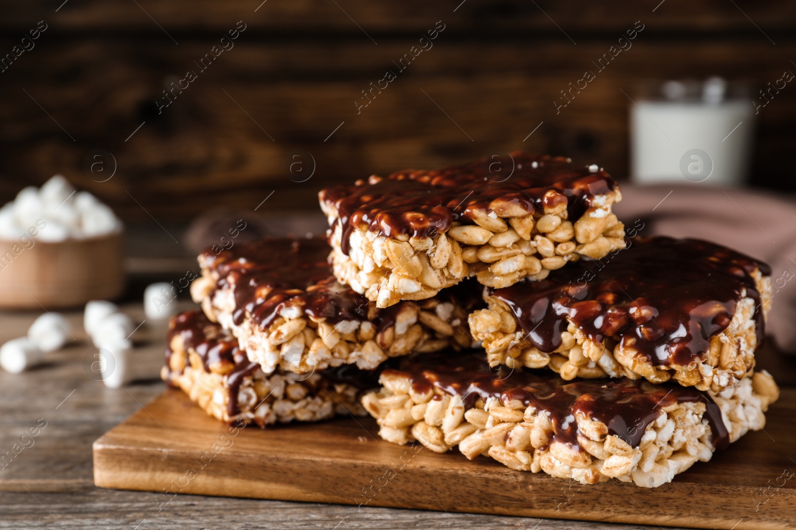 Photo of Delicious rice crispy treats on wooden table, closeup