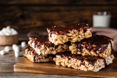 Delicious rice crispy treats on wooden table, closeup