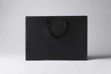 Black paper bag on light grey background