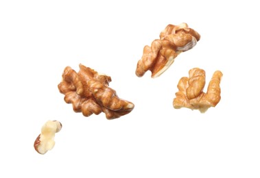 Pieces of walnut falling on white background