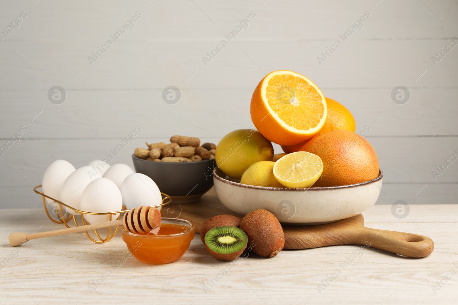 Photo of Allergenic food. Different fresh products on light wooden table