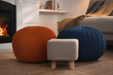 Photo of Stylish comfortable poufs near sofa in room. Home design