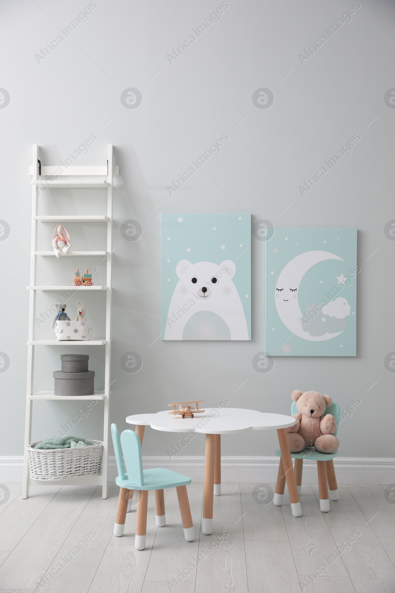 Photo of Children's room interior with table and cute pictures on wall