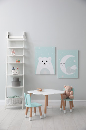 Photo of Children's room interior with table and cute pictures on wall