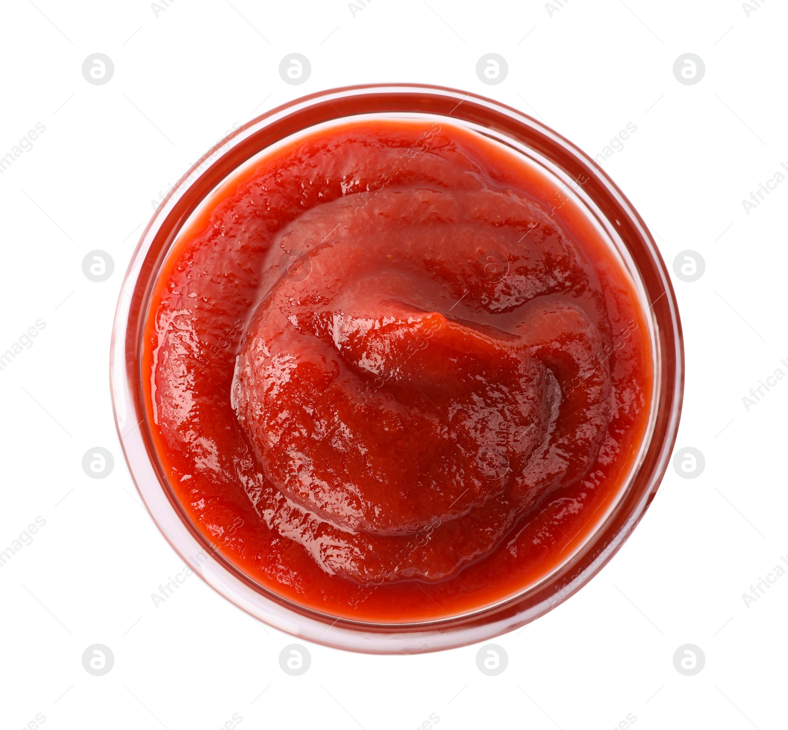 Photo of Tasty ketchup in glass bowl isolated on white, top view