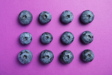 Photo of Flat lay composition with tasty blueberry on color background