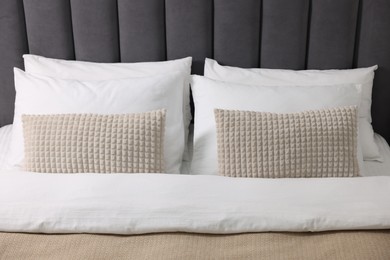 Photo of Soft pillows and warm duvet on bed