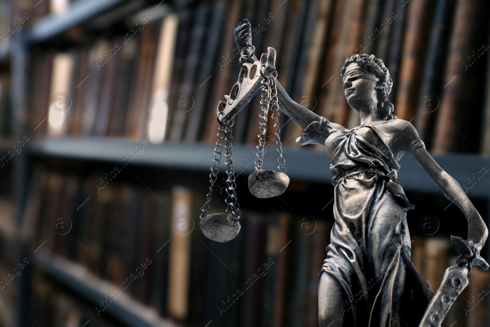 Image of Law and wisdom. Statue of Lady Justice near shelves with books, space for text