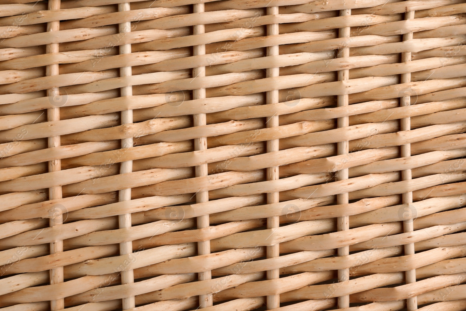 Photo of Handmade wicker basket made of natural material as background, closeup view