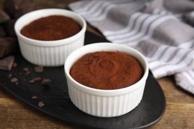 Delicious fresh fondant with chocolate chunks on wooden table, closeup