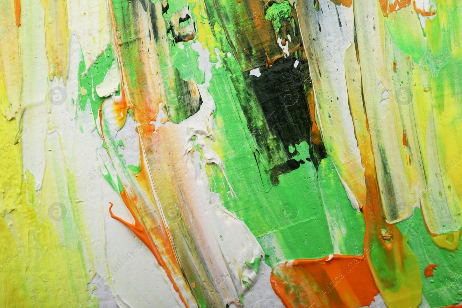 Photo of Beautiful strokes of colorful oil paints as background, closeup