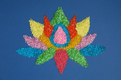 Photo of Diwali celebration. Colorful rangoli on blue background, top view
