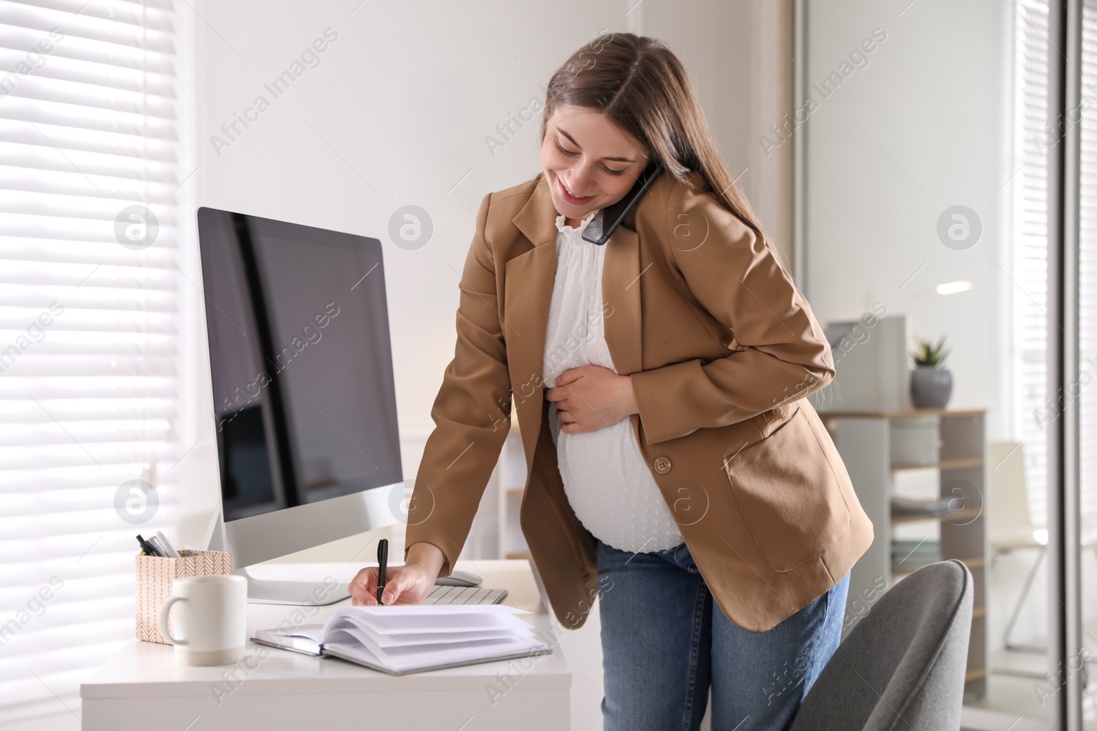 Photo of Pregnant woman working at home. Maternity leave