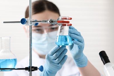 Photo of Young scientist working with samples in laboratory, selective focus