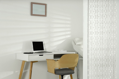 Photo of Doctor's workplace with laptop in modern clinic