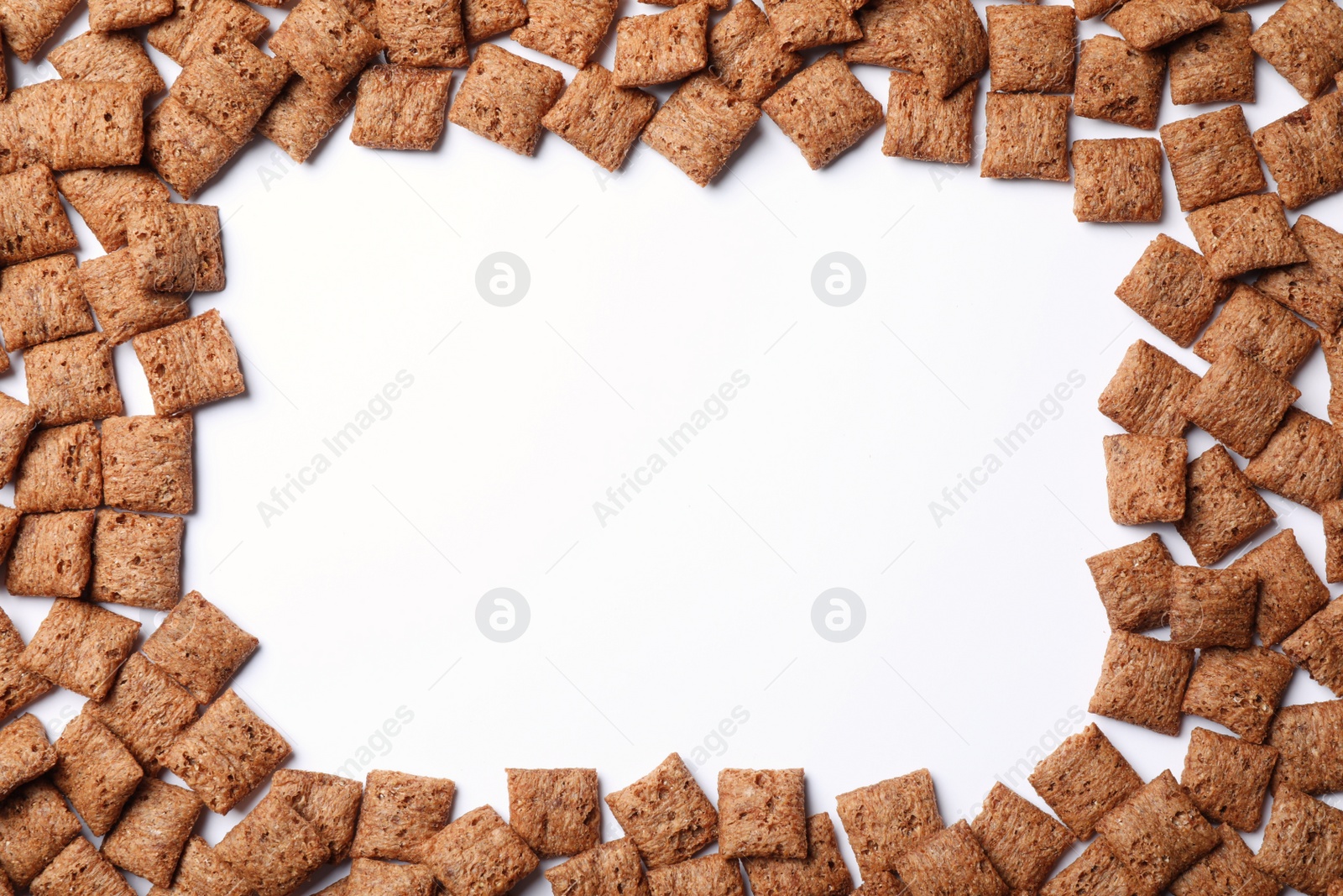 Photo of Frame made with delicious chocolate corn pads on white background, top view. Space for text