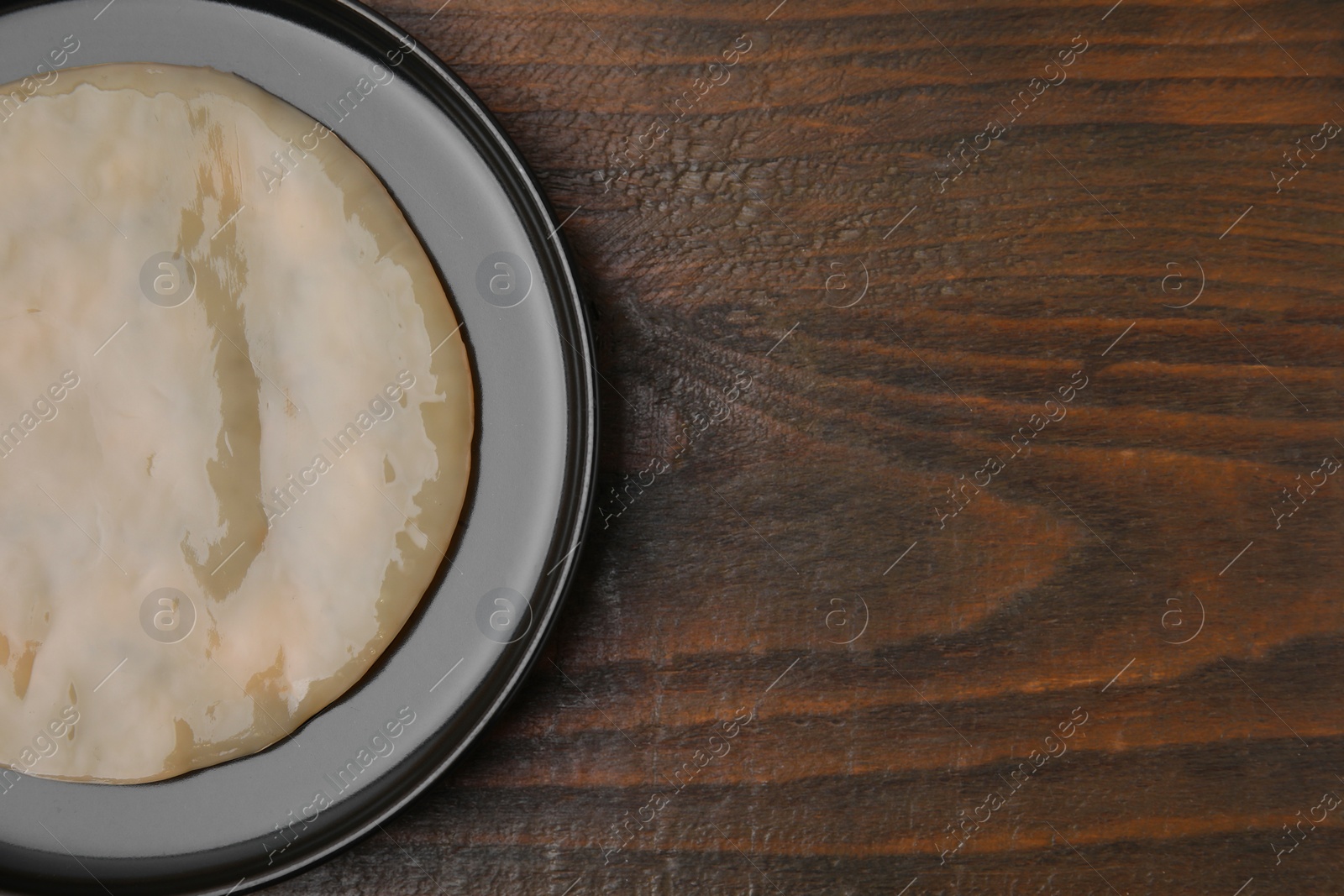 Photo of Making kombucha. Scoby fungus on wooden table, top view. Space for text