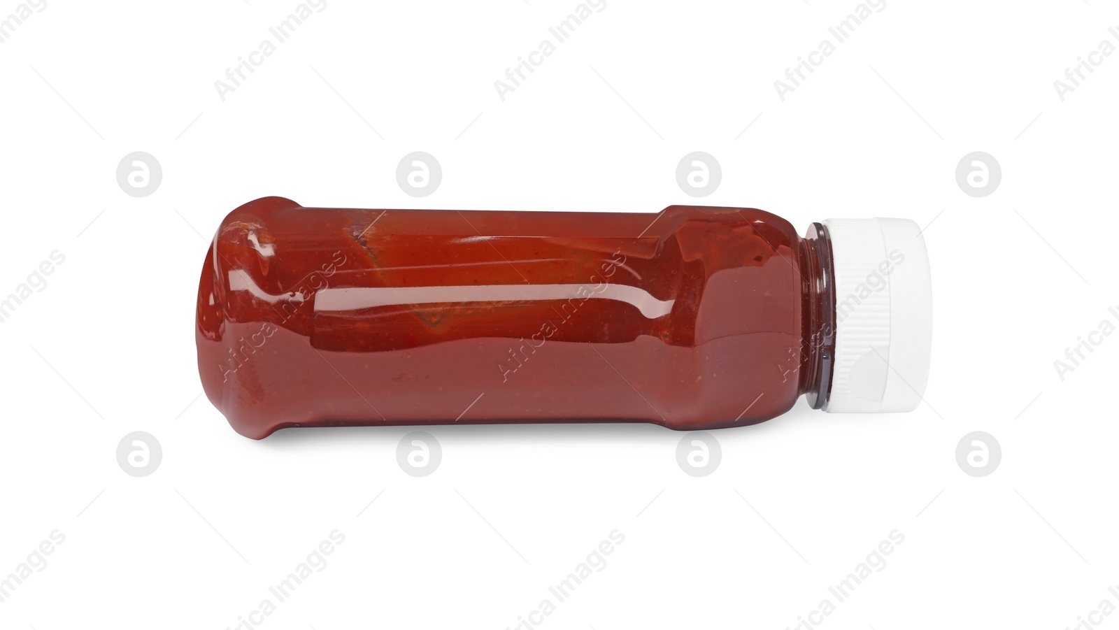 Photo of Bottle of tasty ketchup isolated on white