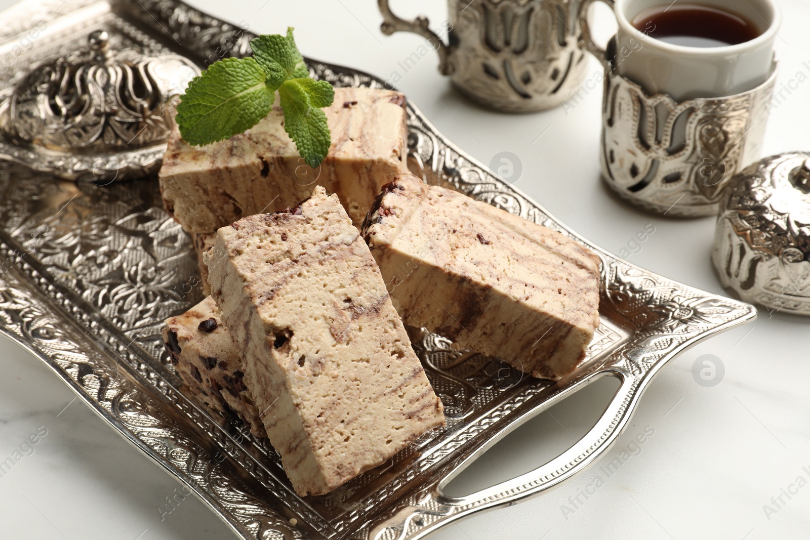 Photo of Tasty chocolate halva served on white marble table