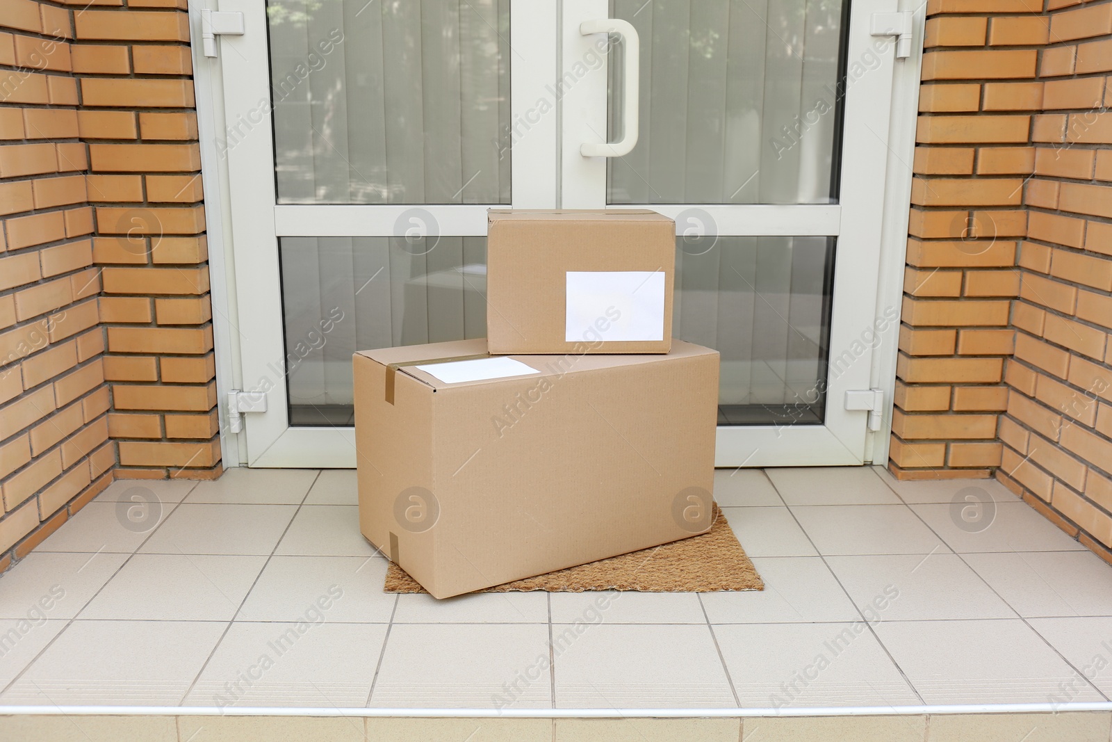 Photo of Delivered parcels on door mat near entrance