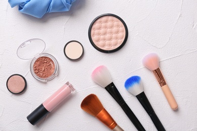 Photo of Flat lay composition with cosmetic products and makeup brushes on light background