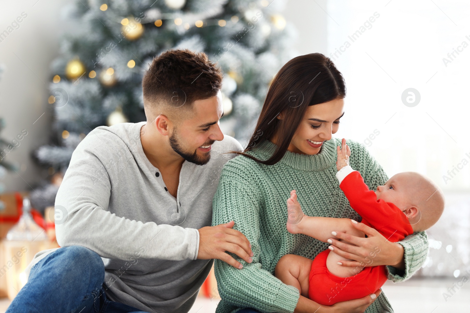 Photo of Happy family with cute baby at home. Christmas celebration