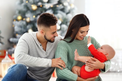 Photo of Happy family with cute baby at home. Christmas celebration