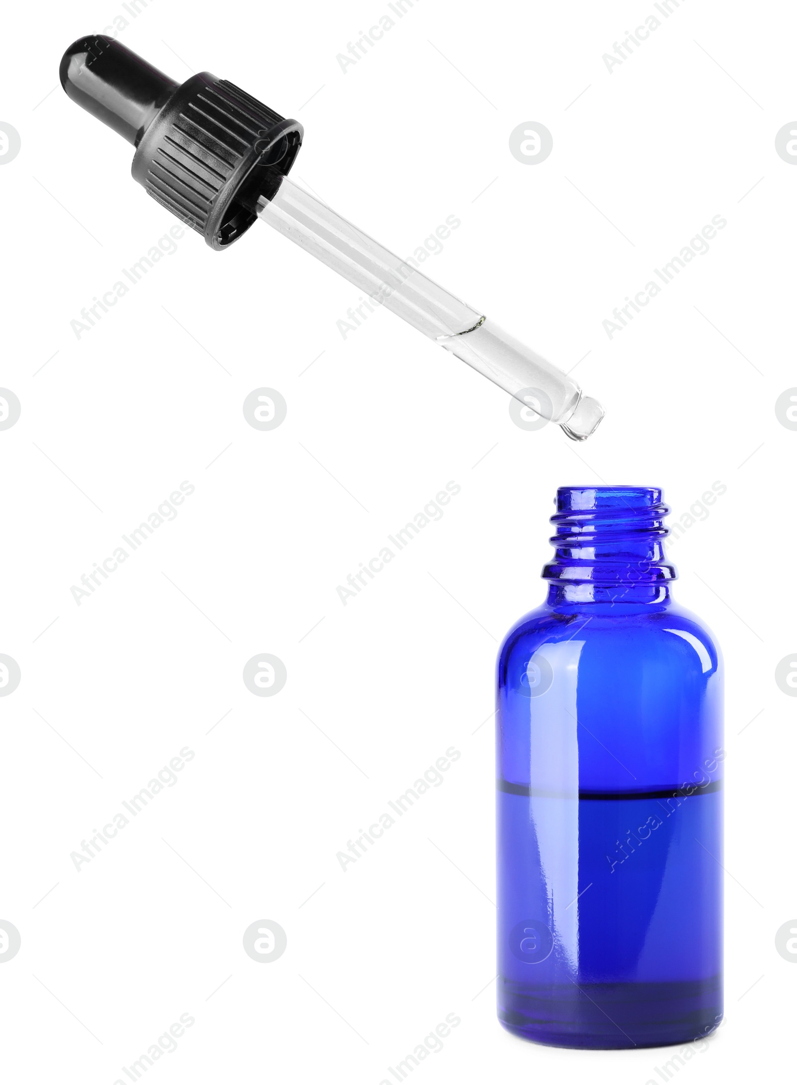 Photo of Dropping herbal essential oil into bottle isolated on white