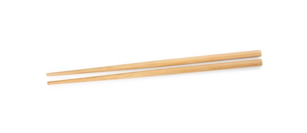 Photo of Pair of wooden chopsticks isolated on white, top view