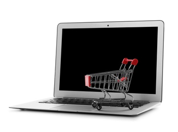 Internet shopping. Laptop with small cart isolated on white