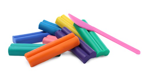 Photo of Many different colorful plasticine pieces and sculpting knife on white background