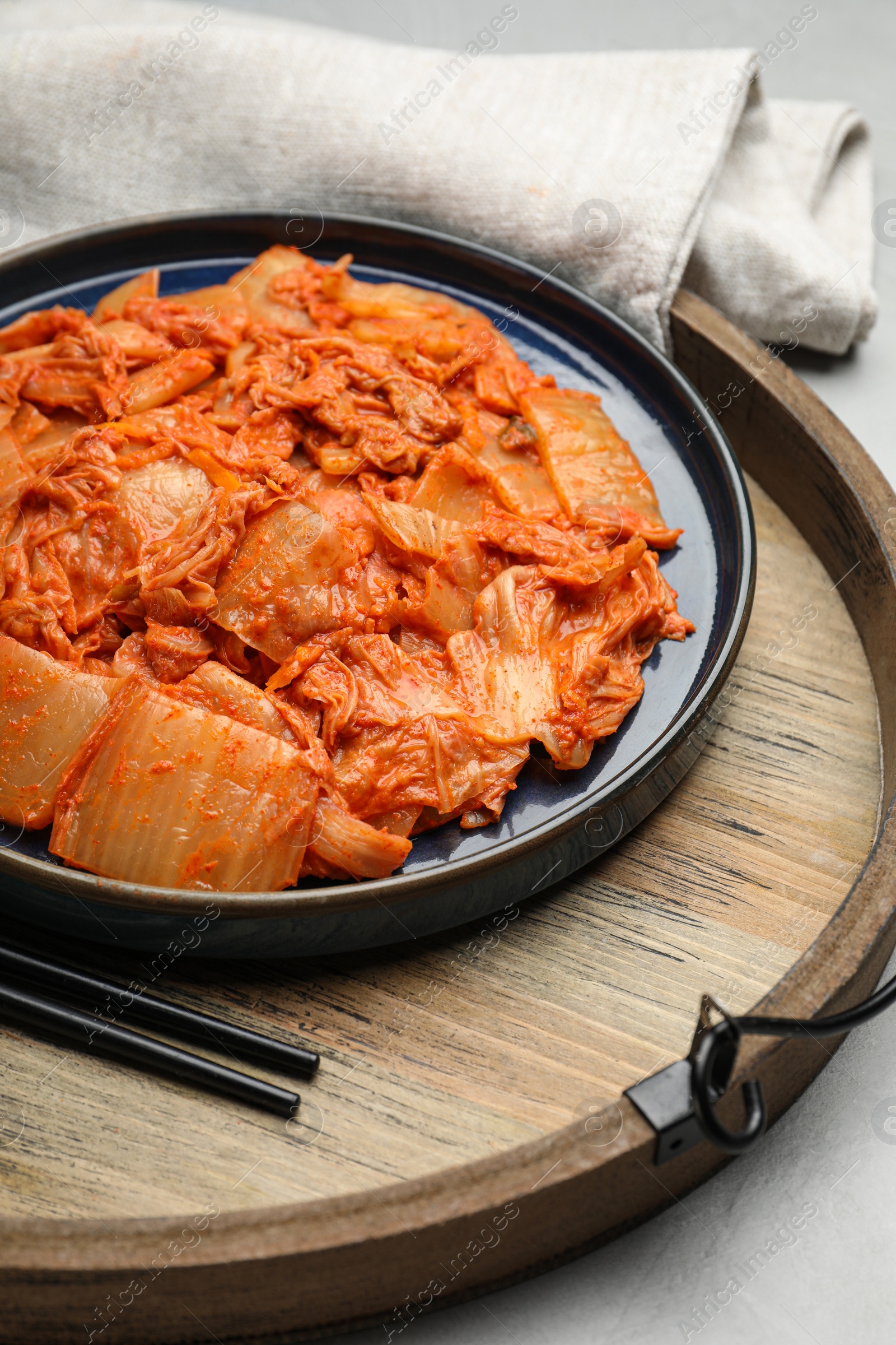 Photo of Delicious kimchi with Chinese cabbage on white table, closeup