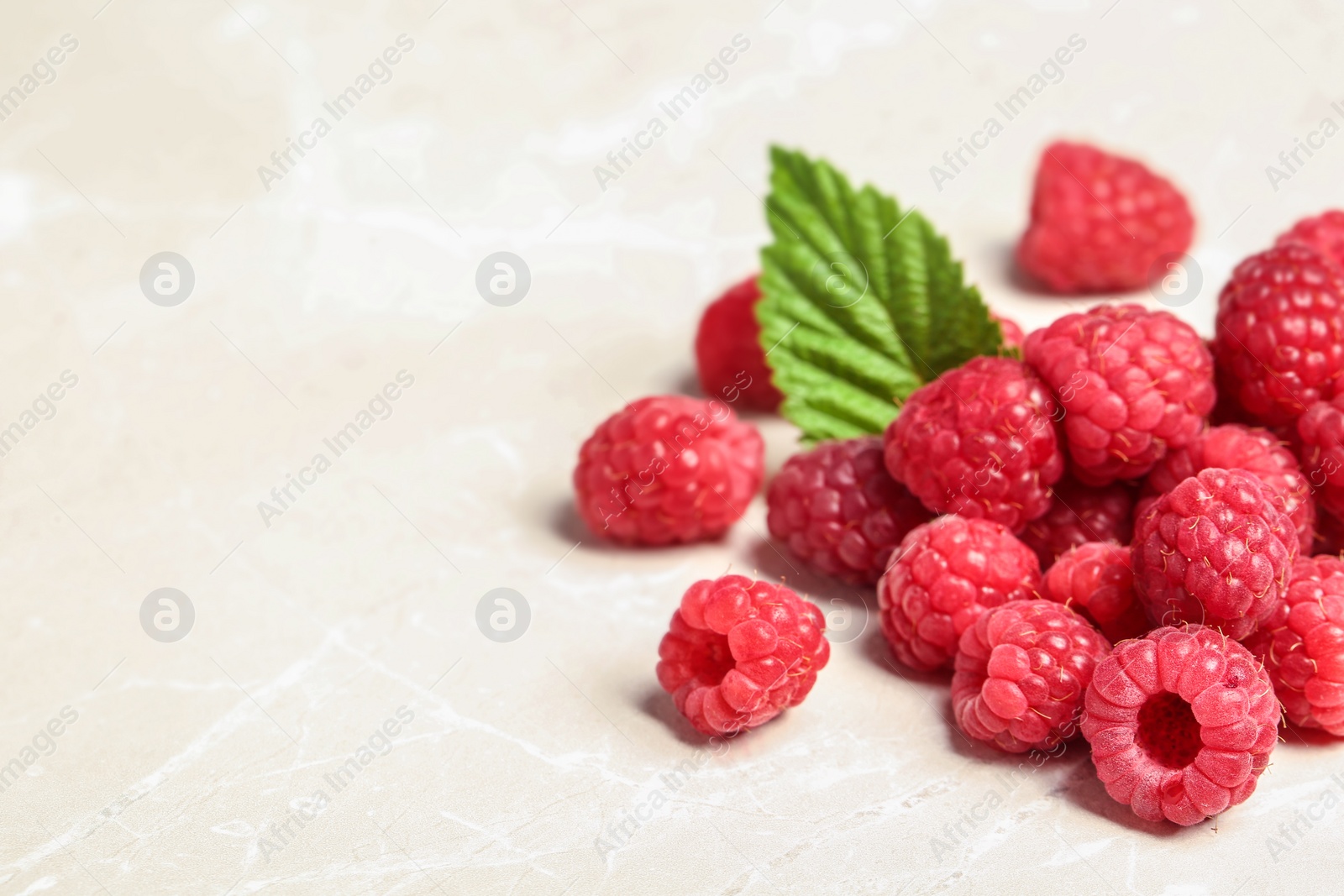 Photo of Ripe aromatic raspberries on table, closeup