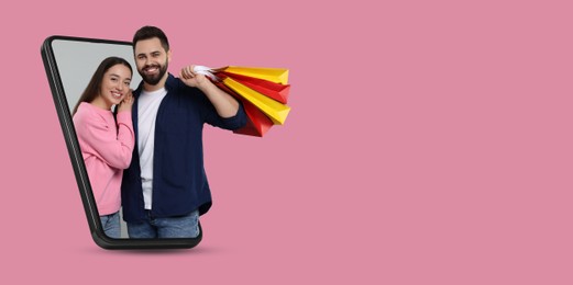 Image of Online shopping. Happy couple with paper bags looking out from smartphone on pink background, space for text. Banner design