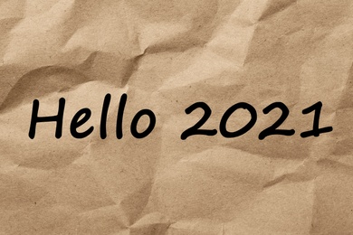 Image of Text Hello 2021 on crumpled paper, top view