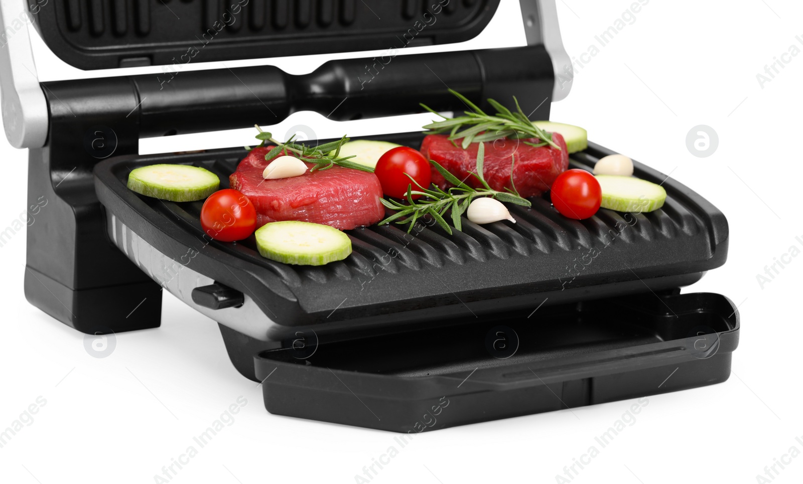 Photo of Electric grill with raw meat, rosemary and vegetables isolated on white