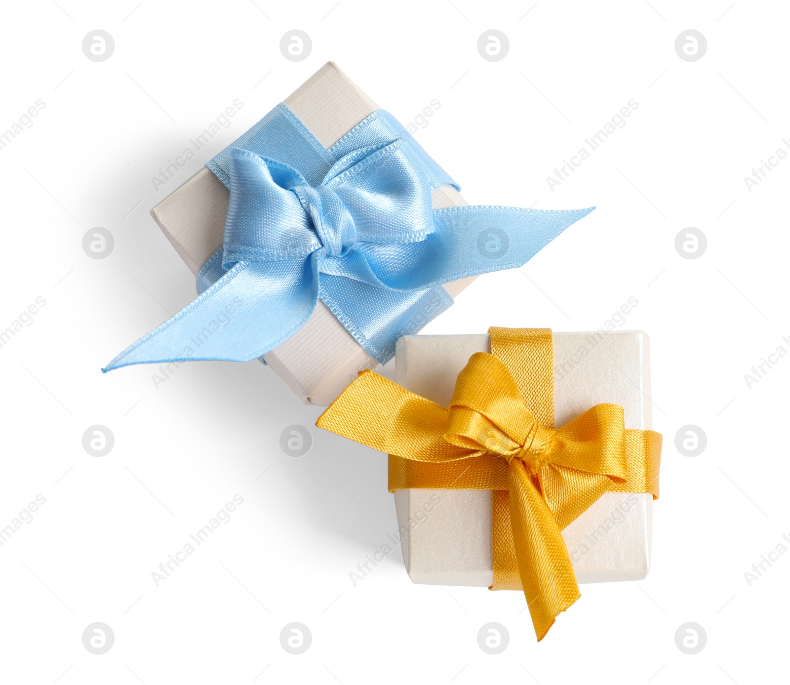 Photo of Beautifully wrapped gift boxes on white background, top view