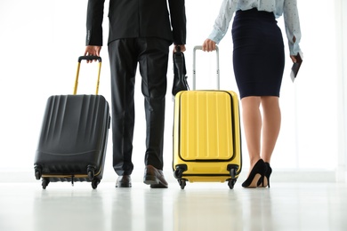 Photo of People with travel suitcases in airport. Business trip