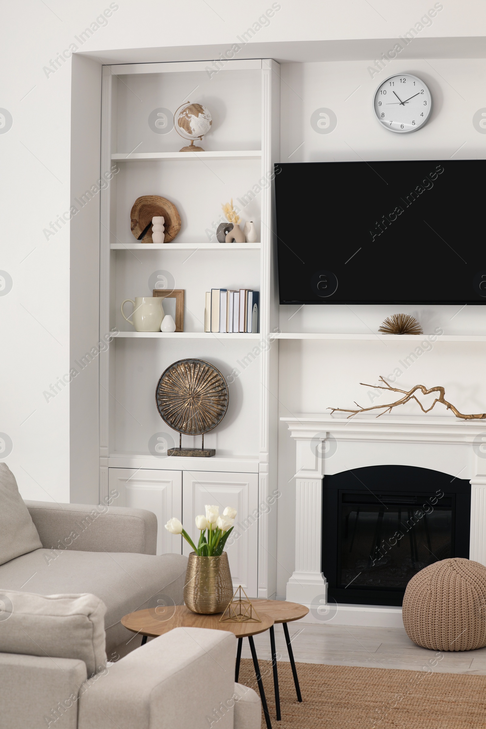 Photo of Cozy room interior with stylish furniture, decorative fireplace and TV set